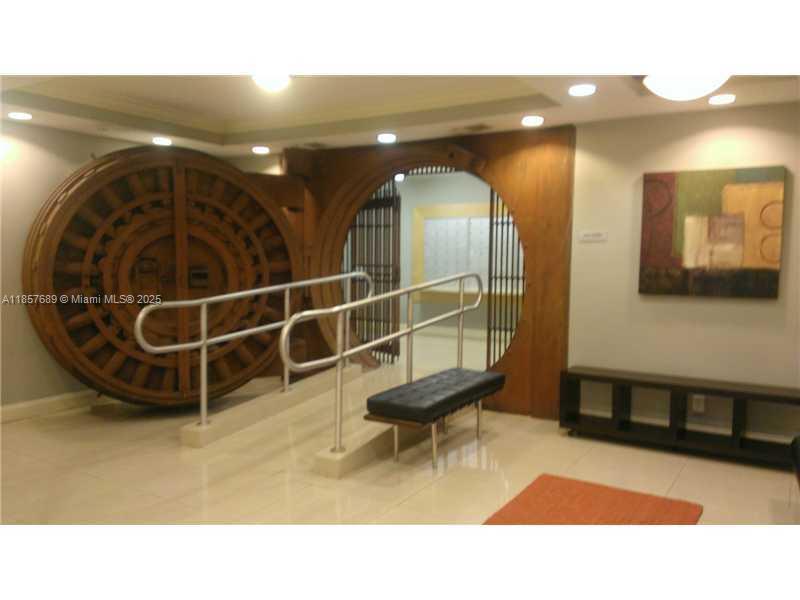 111 East Flagler Street, Unit 1007 Miami, FL 33131 - Photo 10 of 13 a bathroom with a sink and a mirror