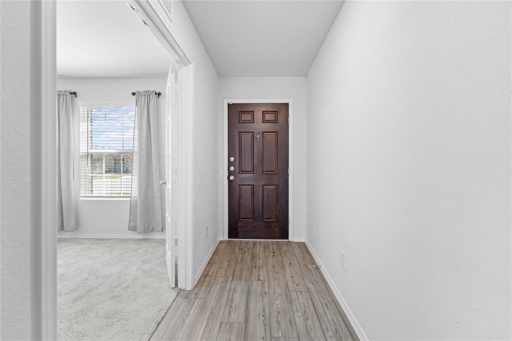 4432 Sagecroft Road Fort Worth, TX 76036 - Photo 14 of 16 Foyer featuring light wood-style floors and baseboards