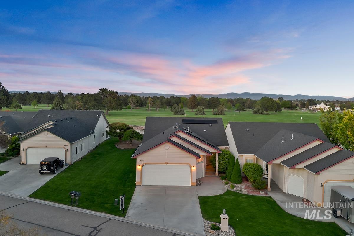 Single-story residence featuring a two-car garage and a paved driveway