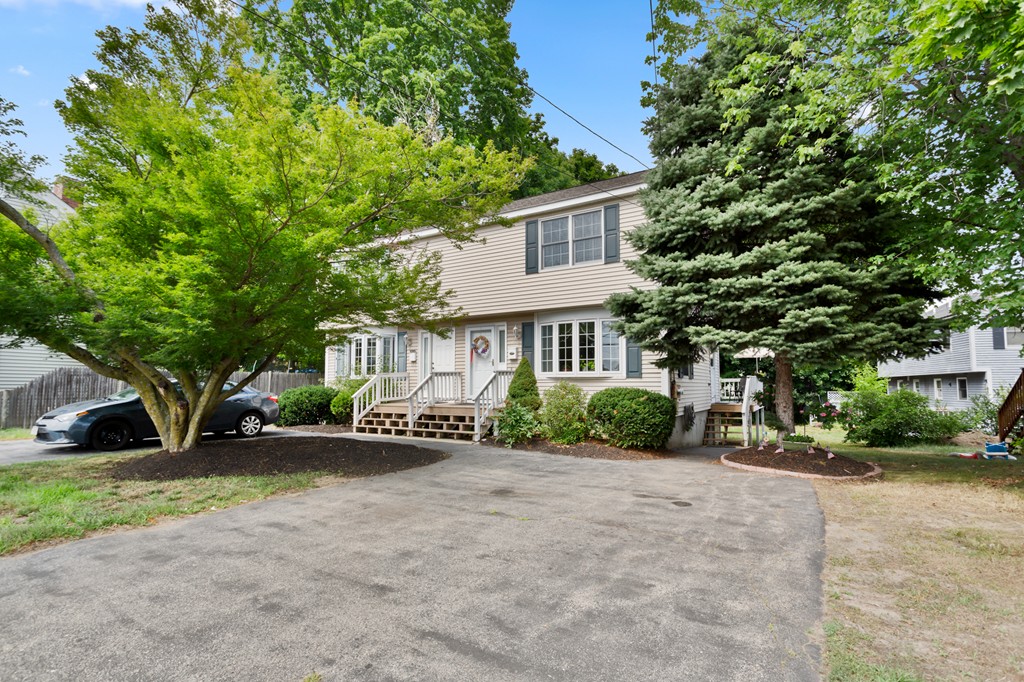 163 Mammoth Road, Unit 163 Lowell, MA 01854 - Photo 1 of 30 a view of a house with a yard