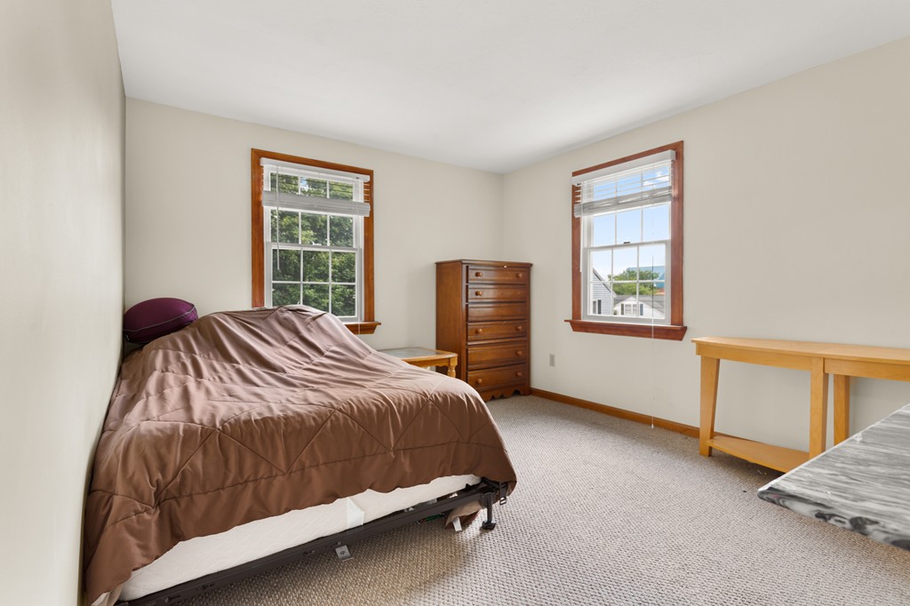 163 Mammoth Road, Unit 163 Lowell, MA 01854 - Photo 17 of 30 a bedroom with a bed and window