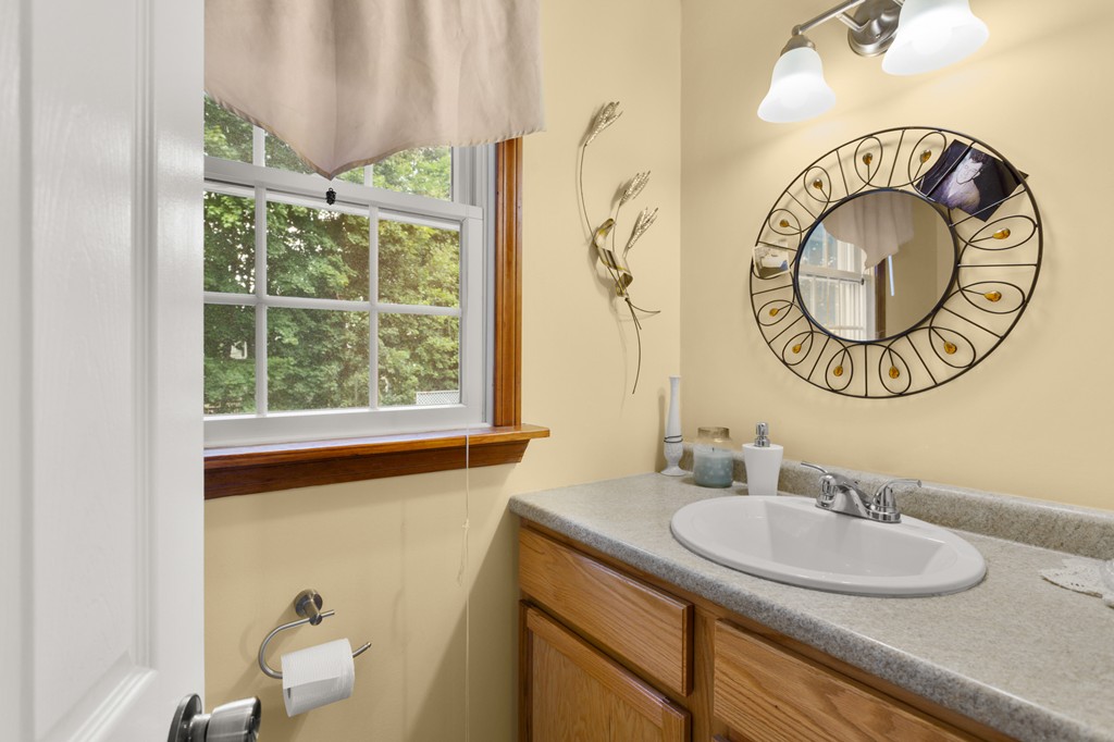 163 Mammoth Road, Unit 163 Lowell, MA 01854 - Photo 9 of 30 a bathroom with a sink and a mirror