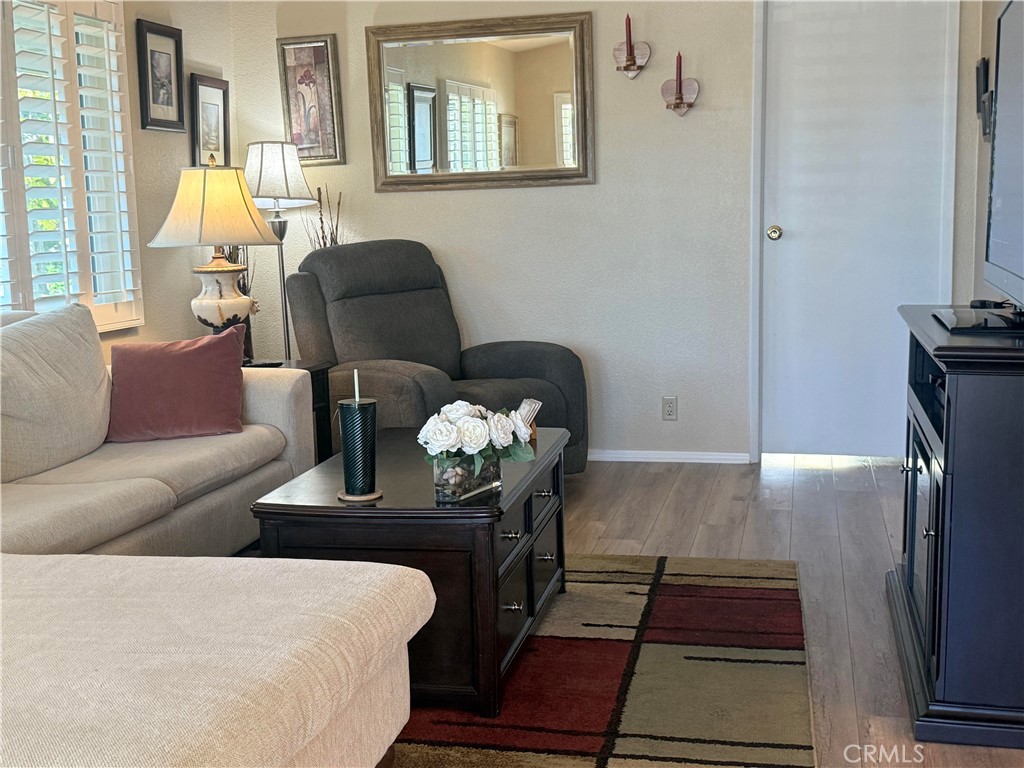 31130 South General Kearny Road, Unit 153 Temecula, CA 92591 - Photo 11 of 38 a living room with furniture and wooden floor