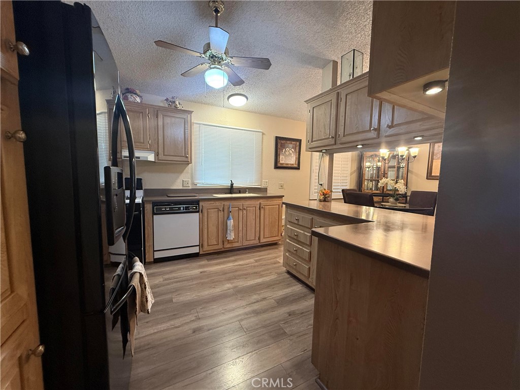 31130 South General Kearny Road, Unit 153 Temecula, CA 92591 - Photo 18 of 38 a kitchen with stainless steel appliances granite countertop a sink a stove and a refrigerator