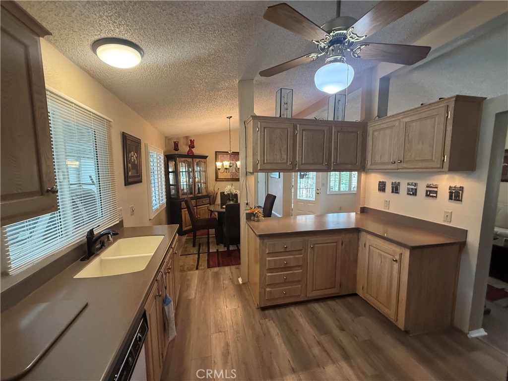 31130 South General Kearny Road, Unit 153 Temecula, CA 92591 - Photo 20 of 38 a kitchen with granite countertop a stove a sink and a refrigerator