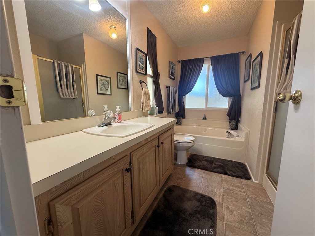 31130 South General Kearny Road, Unit 153 Temecula, CA 92591 - Photo 22 of 38 a bathroom with a double vanity sink a mirror and a bathtub