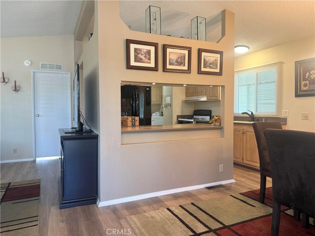 31130 South General Kearny Road, Unit 153 Temecula, CA 92591 - Photo 3 of 38 a view of a dining room with furniture and a fireplace