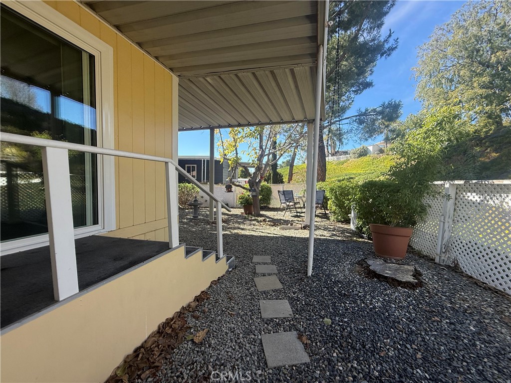 31130 South General Kearny Road, Unit 153 Temecula, CA 92591 - Photo 32 of 38 a view of a patio with chairs and potted plants