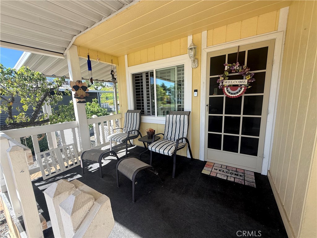31130 South General Kearny Road, Unit 153 Temecula, CA 92591 - Photo 4 of 38 a balcony with furniture and potted plants