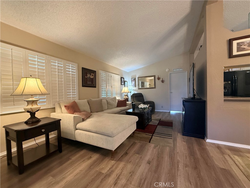 31130 South General Kearny Road, Unit 153 Temecula, CA 92591 - Photo 8 of 38 a living room with furniture and a lamp