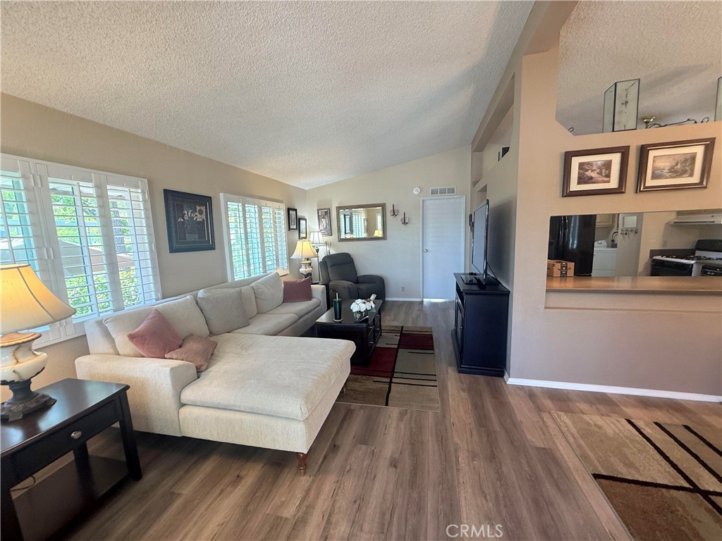 31130 South General Kearny Road, Unit 153 Temecula, CA 92591 - Photo 9 of 38 a living room with furniture and a wooden floor
