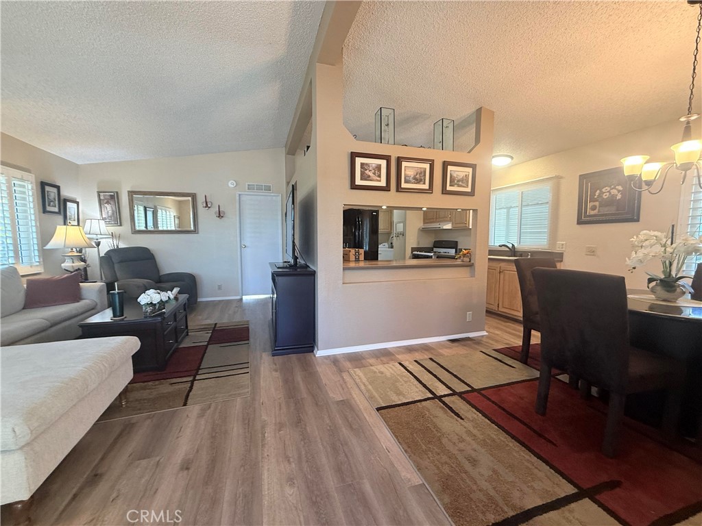 31130 South General Kearny Road, Unit 153 Temecula, CA 92591 - Photo 10 of 38 a living room with furniture and a wooden floor