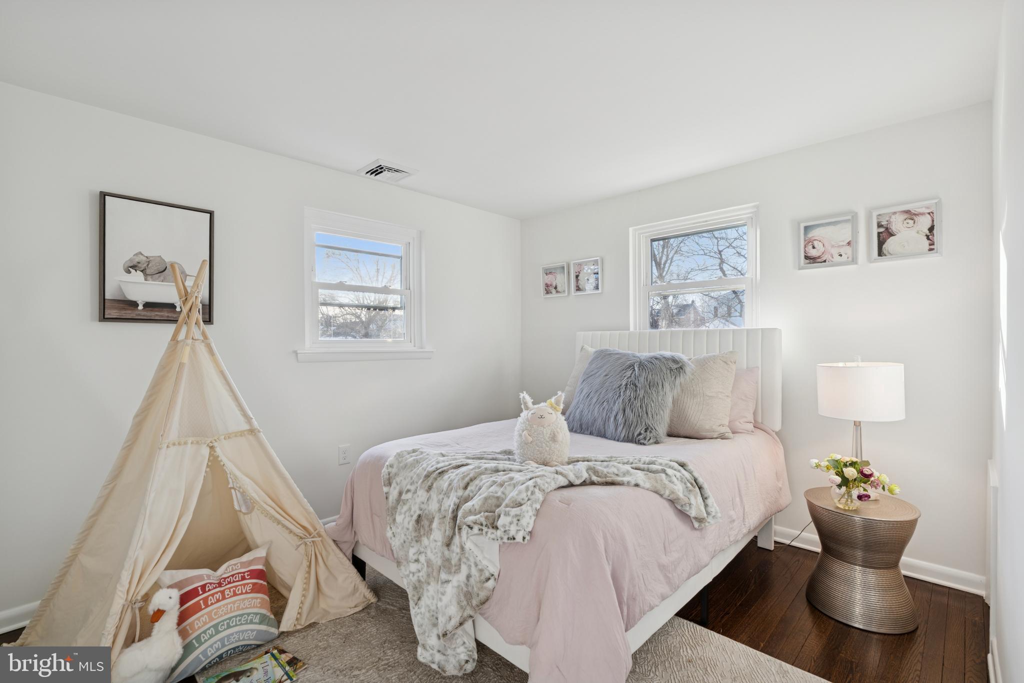 303 Lemon Street Pottstown, PA 19464 - Photo 11 of 15 a bed room with a bed and painting on the wall