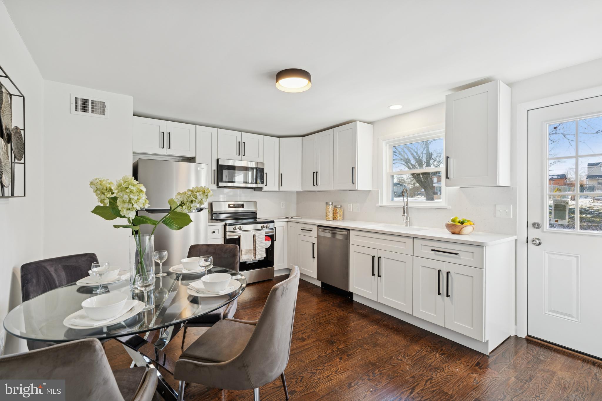 303 Lemon Street Pottstown, PA 19464 - Photo 5 of 15 a kitchen with stainless steel appliances cabinets a dining table and chairs