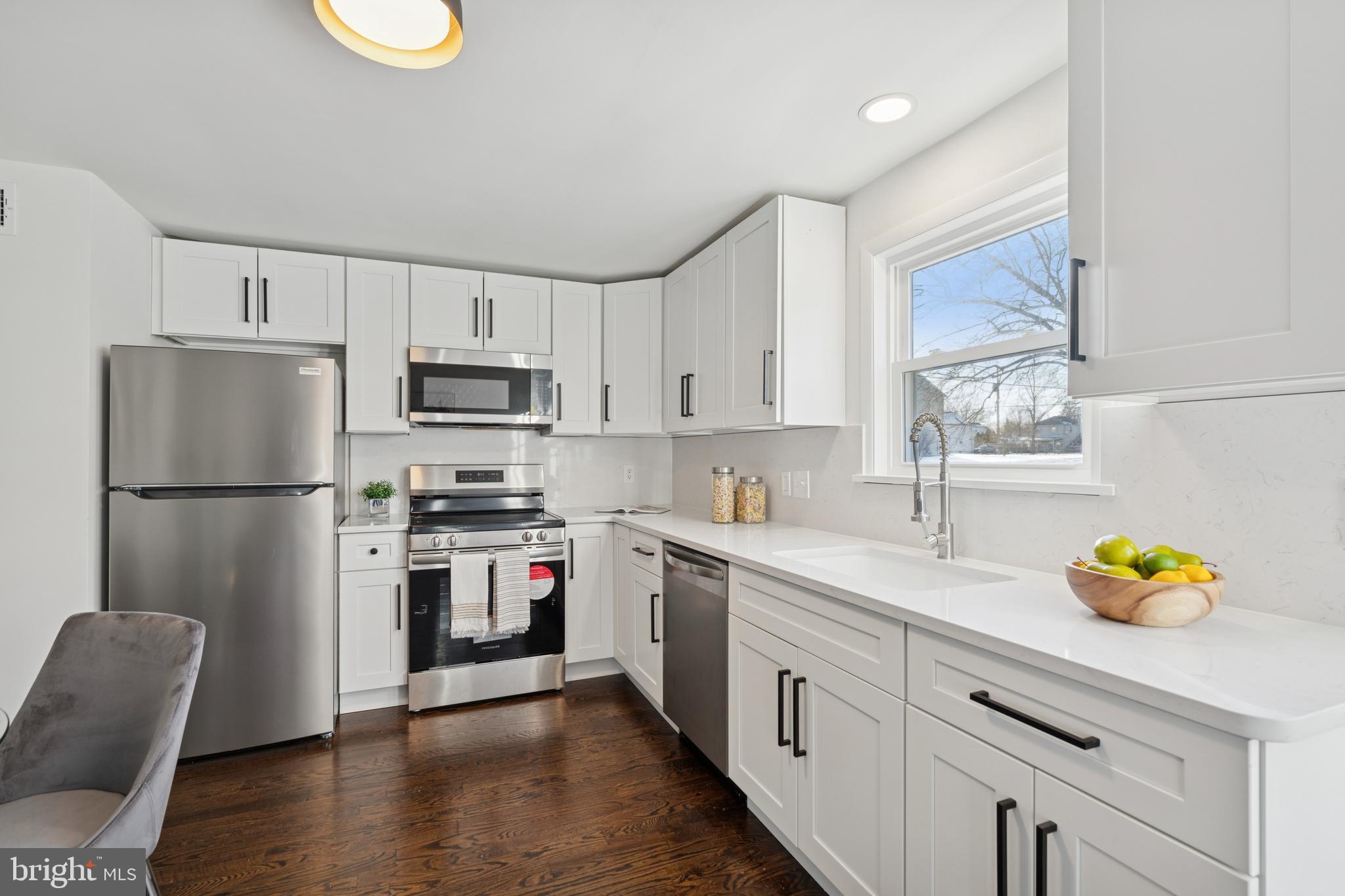 303 Lemon Street Pottstown, PA 19464 - Photo 6 of 15 a kitchen with stainless steel appliances granite countertop a refrigerator sink and stove