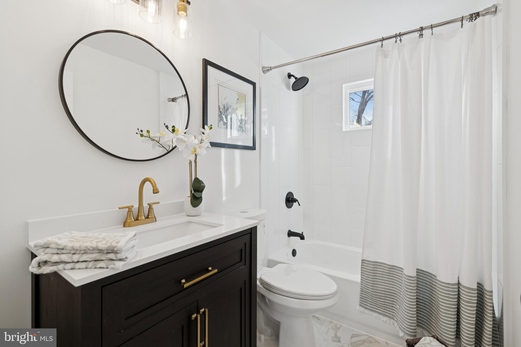 303 Lemon Street Pottstown, PA 19464 - Photo 9 of 15 a bathroom with a granite countertop sink a toilet and a mirror