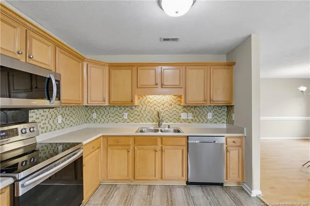 a kitchen with a sink and cabinets