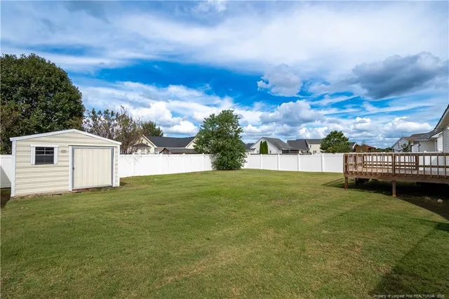 a view of white house with a yard