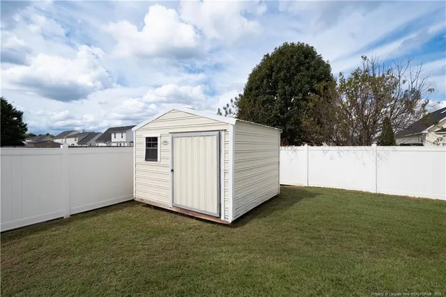 a house view with swimming pool and wooden fence