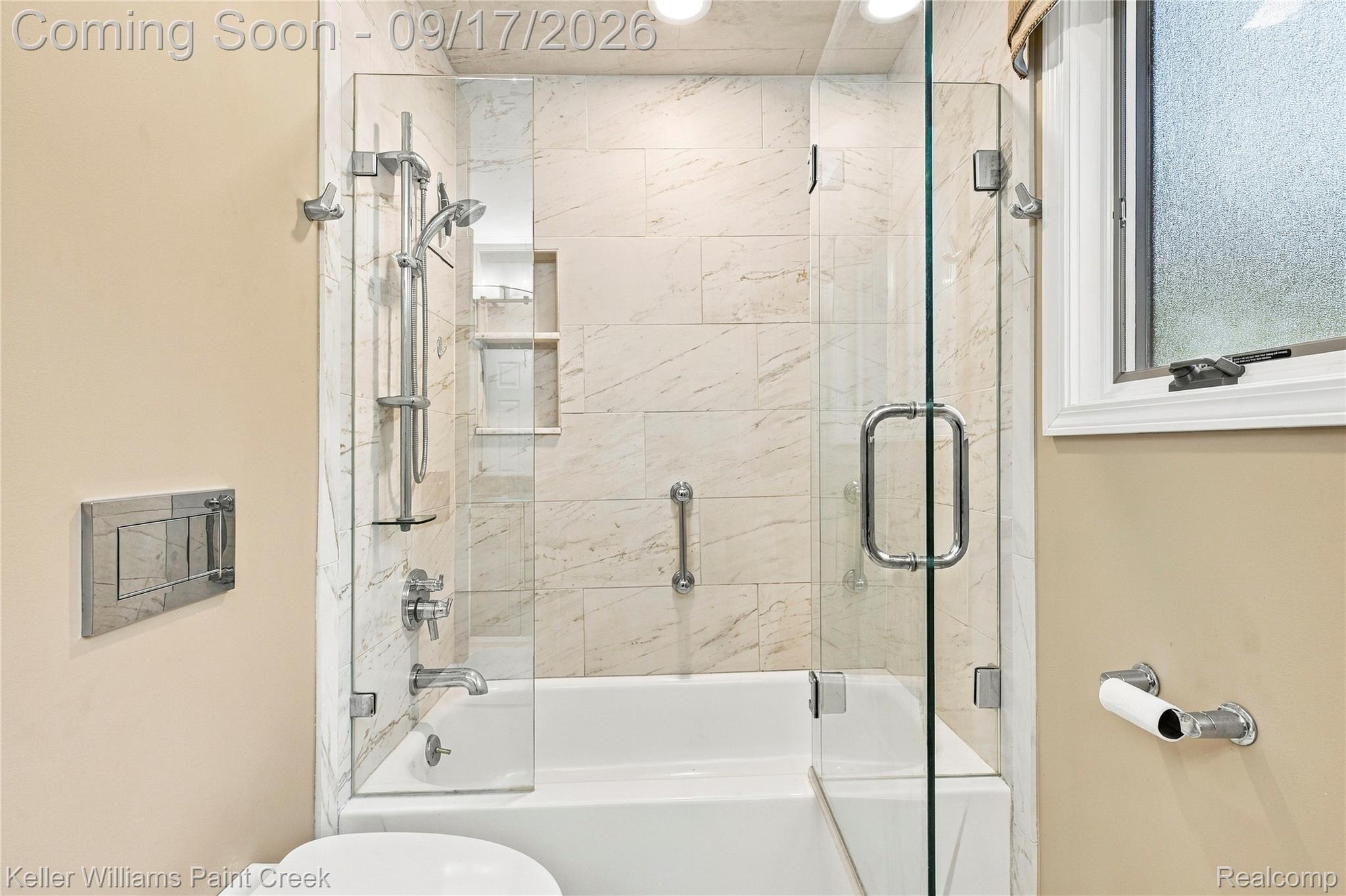 4535 Orion Road Rochester, MI 48306 - Photo 42 of 67 Bathtub with a glass shower enclosure, a handheld shower fixture, and a built-in shower niche