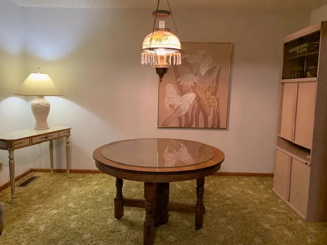 a view of a room with a table and chairs