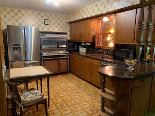 1809 West 19th Plainview, TX 79072 - Photo 6 of 19 a kitchen with stainless steel appliances granite countertop a sink stove and refrigerator