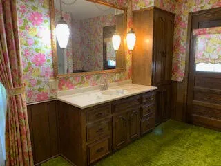 a bathroom with a sink vanity and a mirror