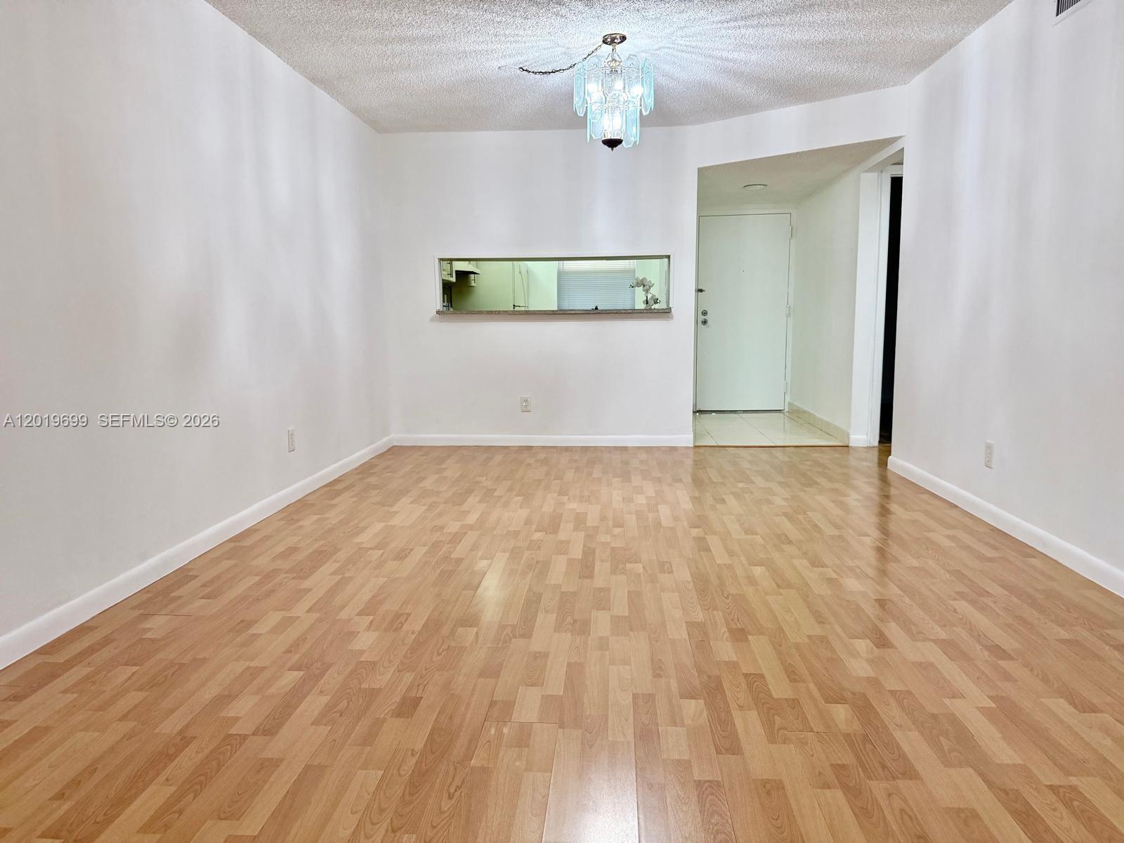 3470 Foxcroft Road, Unit 204 Miramar, FL 33025 - Photo 9 of 40 wooden floor in an empty room with a window