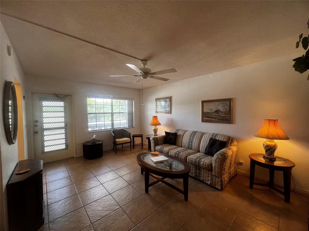 2050 Northeast 39th Street, Unit 209W Lighthouse Point, FL 33064 - Photo 1 of 27 a living room with furniture and a window