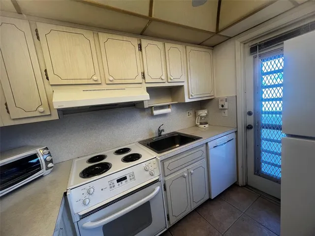 a kitchen with stainless steel appliances granite countertop a stove and a sink