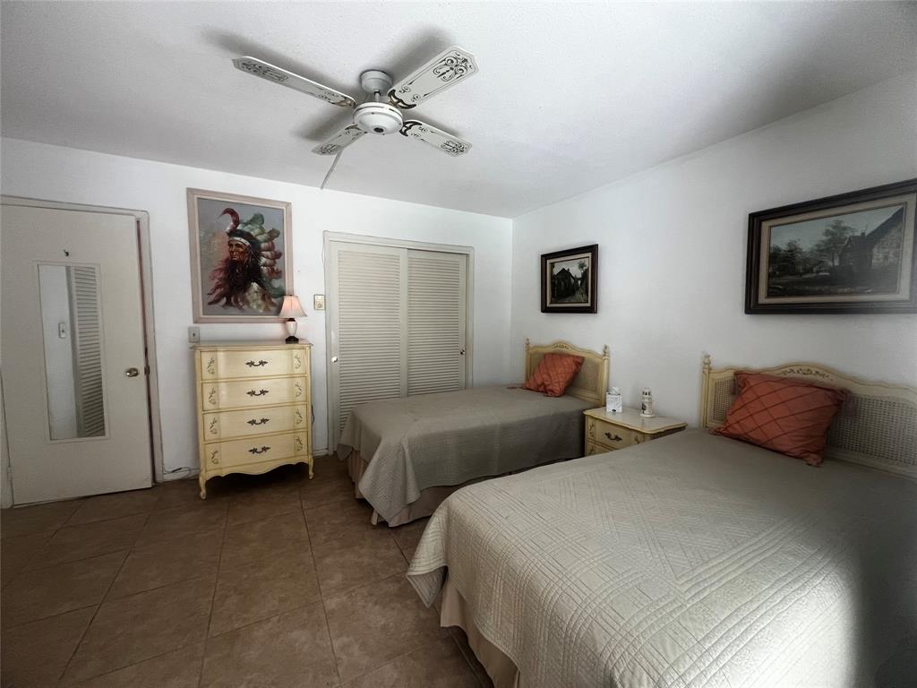 2050 Northeast 39th Street, Unit 209W Lighthouse Point, FL 33064 - Photo 17 of 27 a bedroom with two beds and a television
