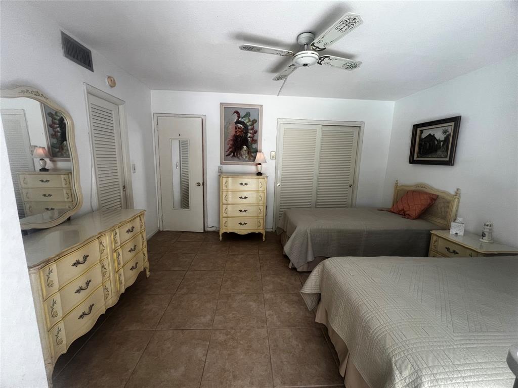 2050 Northeast 39th Street, Unit 209W Lighthouse Point, FL 33064 - Photo 18 of 27 a bedroom with furniture and white walls
