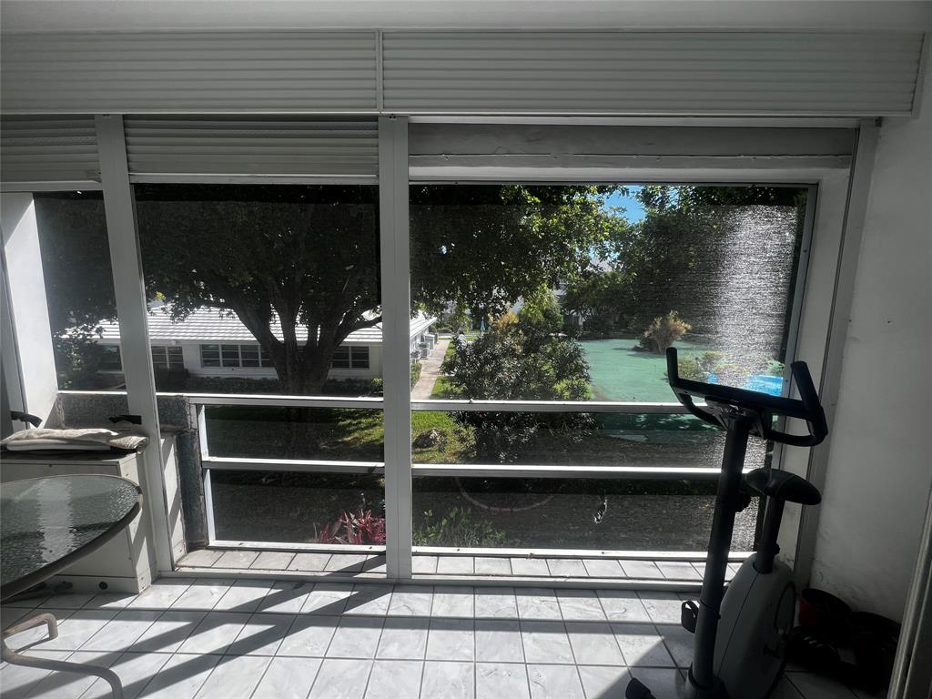 2050 Northeast 39th Street, Unit 209W Lighthouse Point, FL 33064 - Photo 21 of 27 a front view of a house with a window