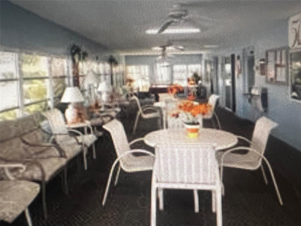 2050 Northeast 39th Street, Unit 209W Lighthouse Point, FL 33064 - Photo 22 of 27 a view of a dining room with furniture and chandelier