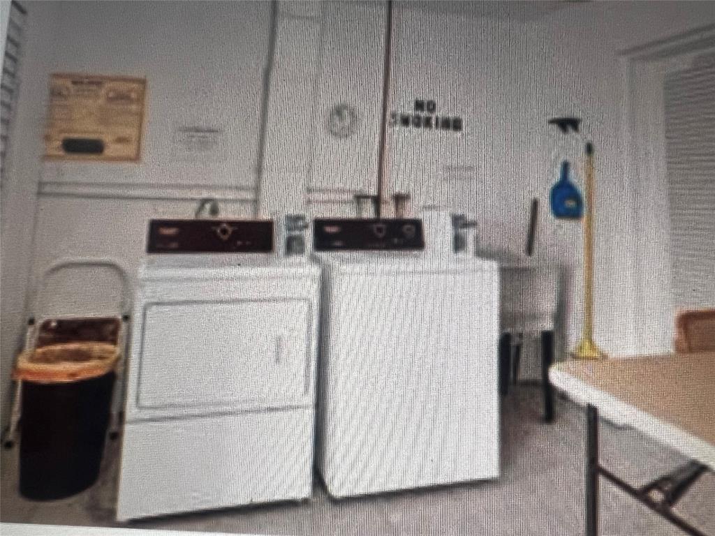 2050 Northeast 39th Street, Unit 209W Lighthouse Point, FL 33064 - Photo 23 of 27 a utility room with dryer and washer