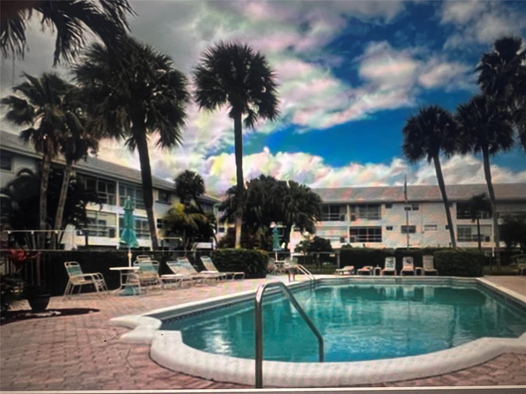 2050 Northeast 39th Street, Unit 209W Lighthouse Point, FL 33064 - Photo 24 of 27 a swimming pool view with a seating space