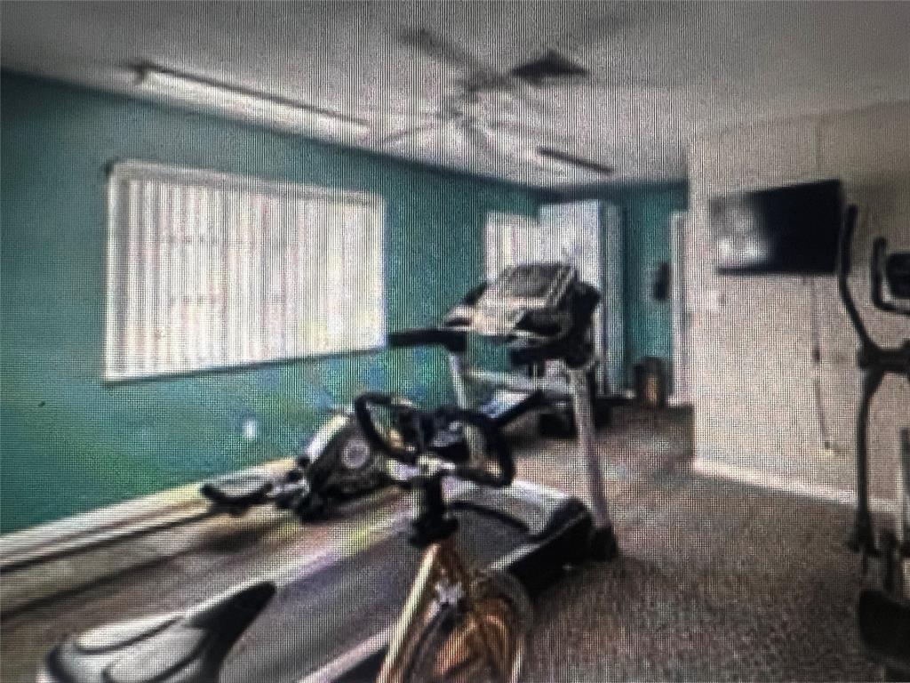 2050 Northeast 39th Street, Unit 209W Lighthouse Point, FL 33064 - Photo 26 of 27 a view of a room with gym equipment