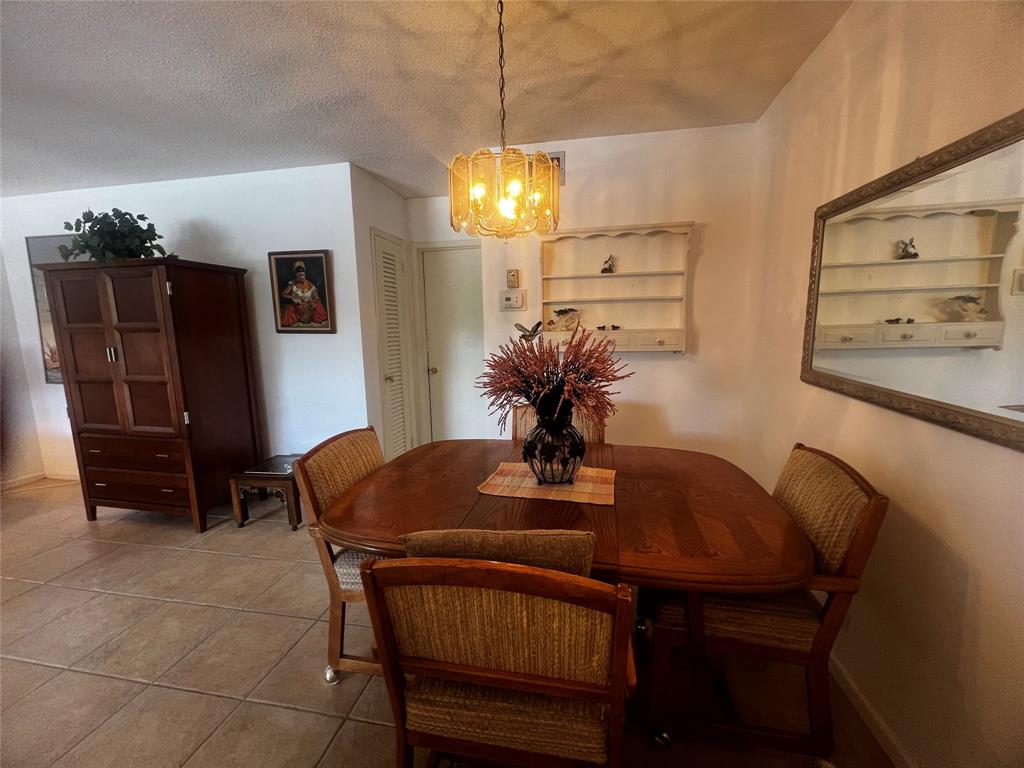 2050 Northeast 39th Street, Unit 209W Lighthouse Point, FL 33064 - Photo 5 of 27 a dining room with furniture and chandelier