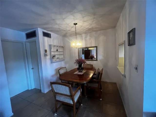 a view of a dining room with furniture and a flat screen tv