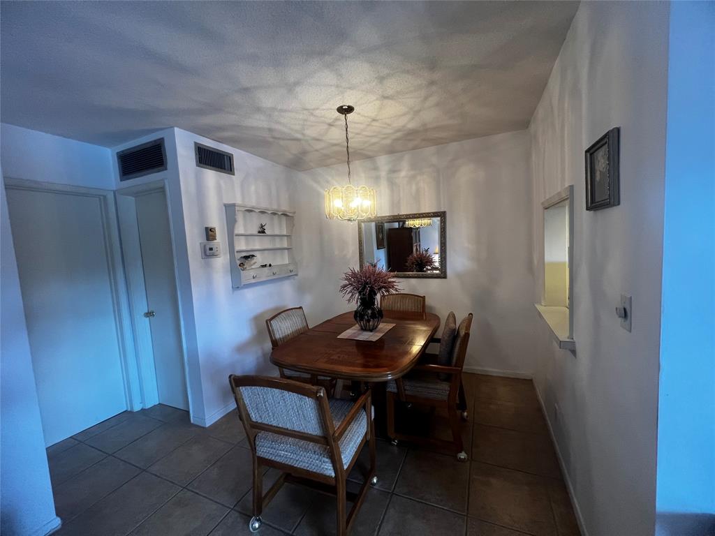 2050 Northeast 39th Street, Unit 209W Lighthouse Point, FL 33064 - Photo 6 of 27 a view of a dining room with furniture and a flat screen tv
