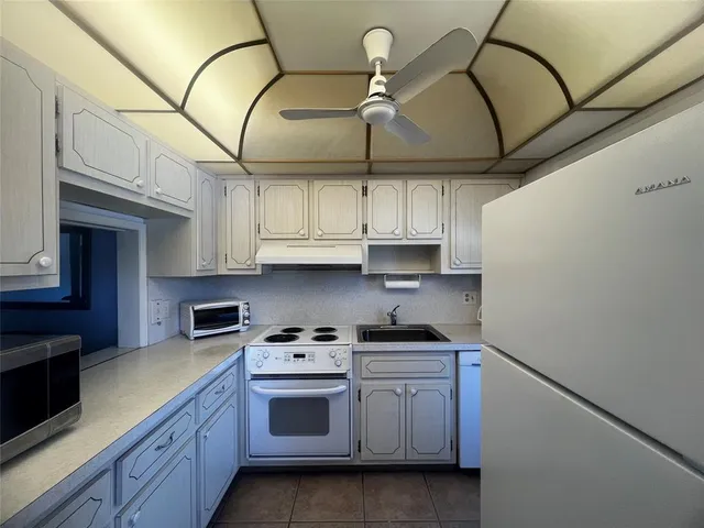 a kitchen with stainless steel appliances a stove a sink and cabinets