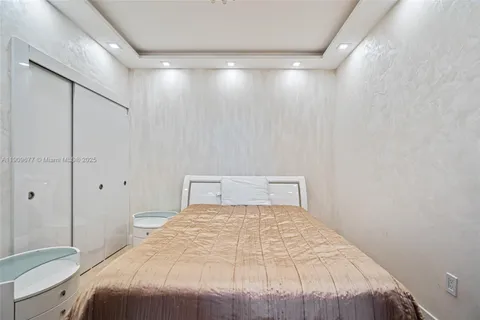 a bedroom with a large bed and a shower