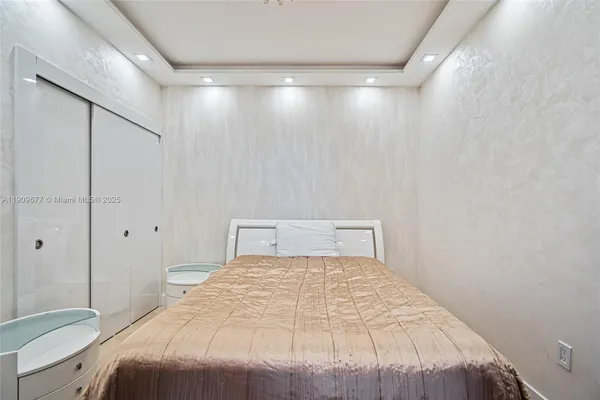 a bedroom with a large bed and a shower