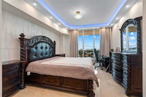 a bedroom with a bed and dresser with mirror