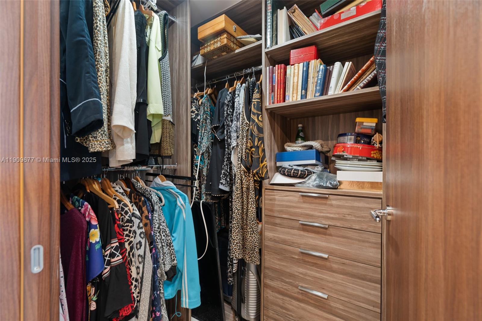 9559 Collins Avenue, Unit S8F Surfside, FL 33154 - Photo 15 of 27 a view of walk in closet with clothes and shoes