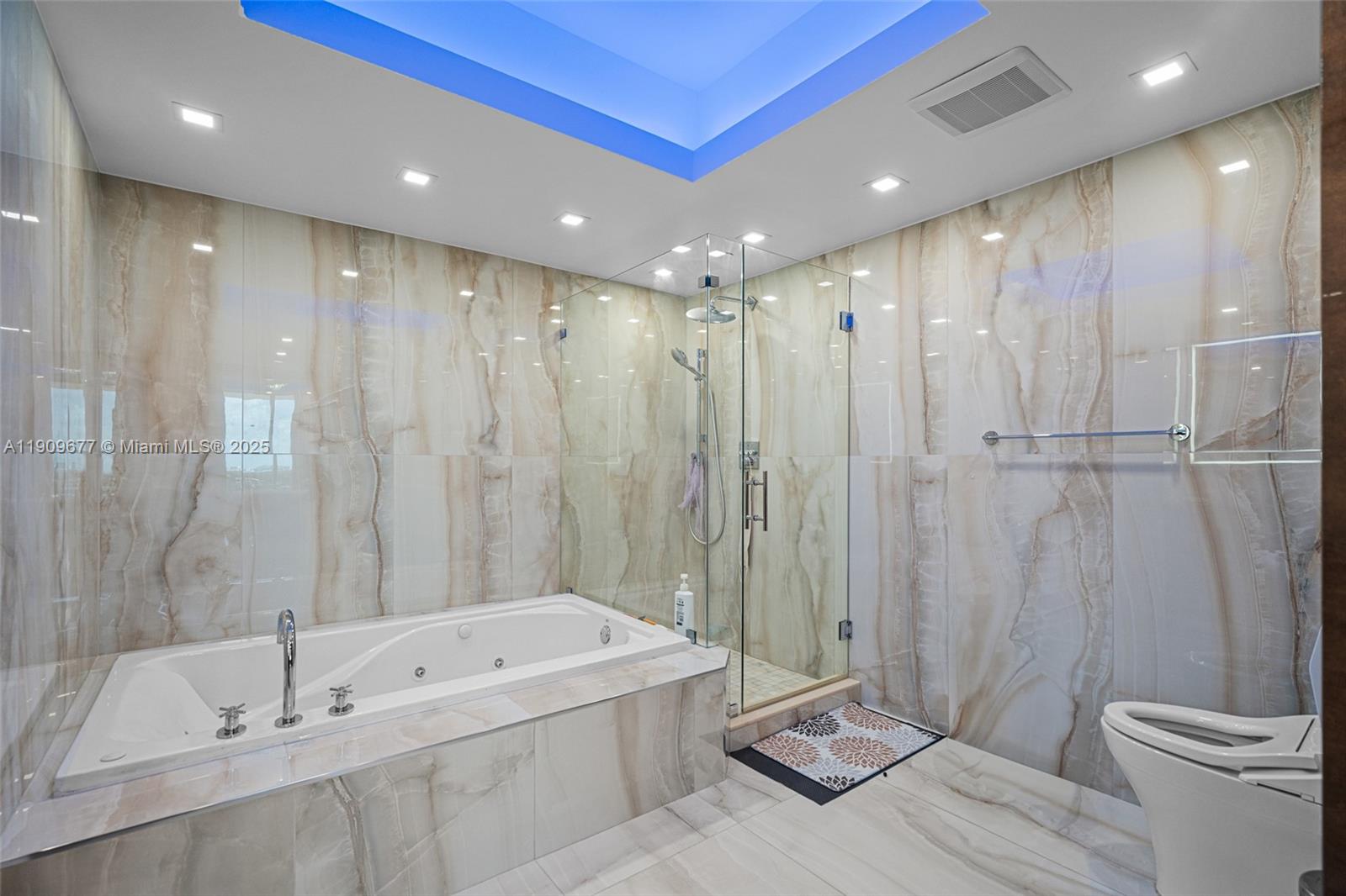 9559 Collins Avenue, Unit S8F Surfside, FL 33154 - Photo 17 of 27 a bathroom with a tub a toilet and a shower