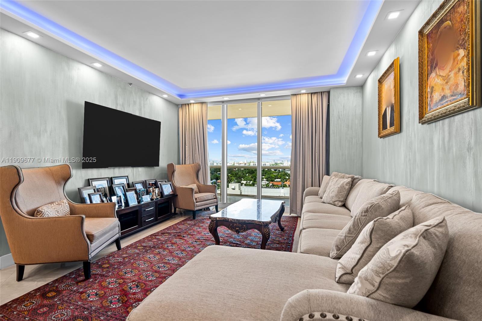 9559 Collins Avenue, Unit S8F Surfside, FL 33154 - Photo 4 of 27 a living room with furniture and a flat screen tv