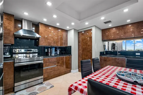 a kitchen with stainless steel appliances granite countertop a stove and a refrigerator