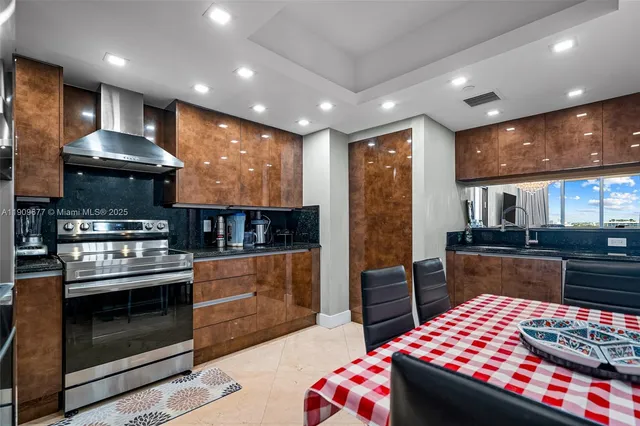 a kitchen with stainless steel appliances granite countertop a stove and a refrigerator