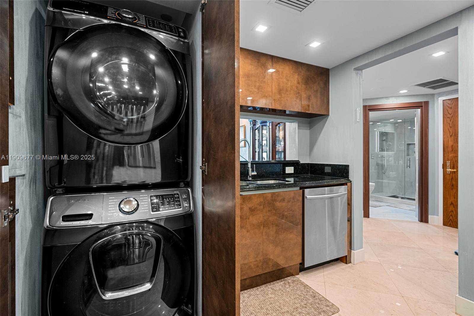 9559 Collins Avenue, Unit S8F Surfside, FL 33154 - Photo 9 of 27 a view of washer and dryer with kitchen in the background